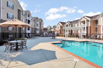Resort-style pool with fountains, pergolas and a fireplace